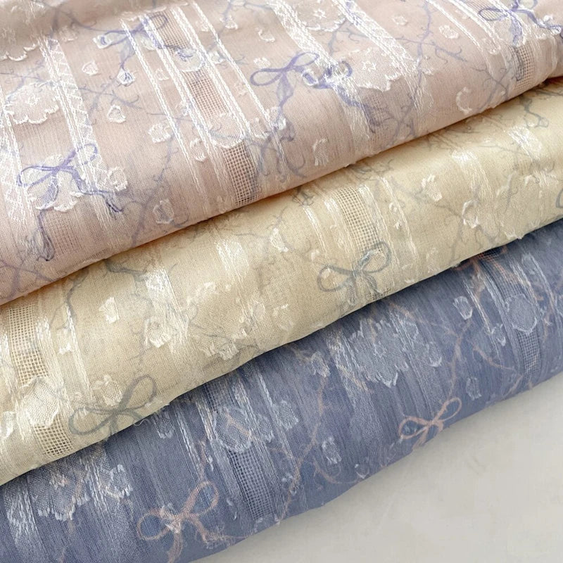 tissu polyester coton rose clair beige bleu clair motif nœuds fleurs élégant romantique 150cm