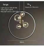 lumière suspendue moderne pendentif géométrique transparent cercles métalliques dorés chambre salon