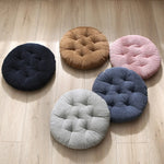 Coussin rond velours côtelé bourgogne sur sol salon