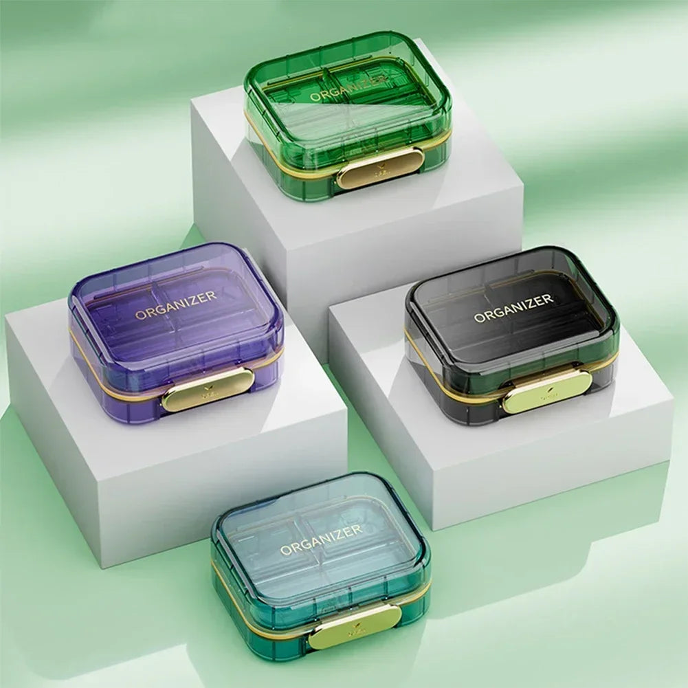 boîte rangement médicaments réutilisable transparente moderne vert bleu violet poignée dorée compartments