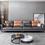 Canapé d'angle moderne cuir gris chaise lounge pieds noirs coussins géométriques salon bois composite