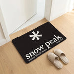 tapis sol noir logo snow peak minimaliste antidérapant bain moderne camping usage