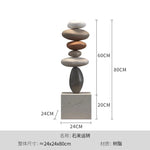 décoration intérieure sculpture pierre équilibrée socle marbre nuance beige contemporain minimaliste salon chambre