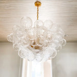 suspension lumineuse moderne verre transparent chaîne dorée led acier poli contemporain lumière chaude chambre