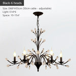 chandelier noir moderne cristaux transparents ampoules blanc chaud suspension élégante branches floralesstylisées
