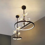 suspension lumineuse moderne sphères verre transparent anneaux métalliques noir doré grisclair