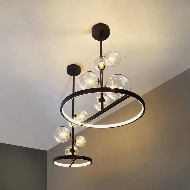 suspension lumineuse moderne sphères verre transparent anneaux métalliques noir doré grisclair
