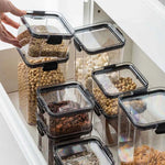 boîtes rangement alimentaire transparentes poignées noires multiple tailles réutilisables modernes pratiques épices pâtes graines