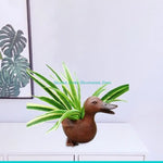 pots résine canard marron plante verte rouge fleurs artificielles feuilles rayées tableaux tropicaux