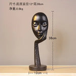 masque sculptural contemporain noir blanc doré finement sculpté base circulaire ornement salon