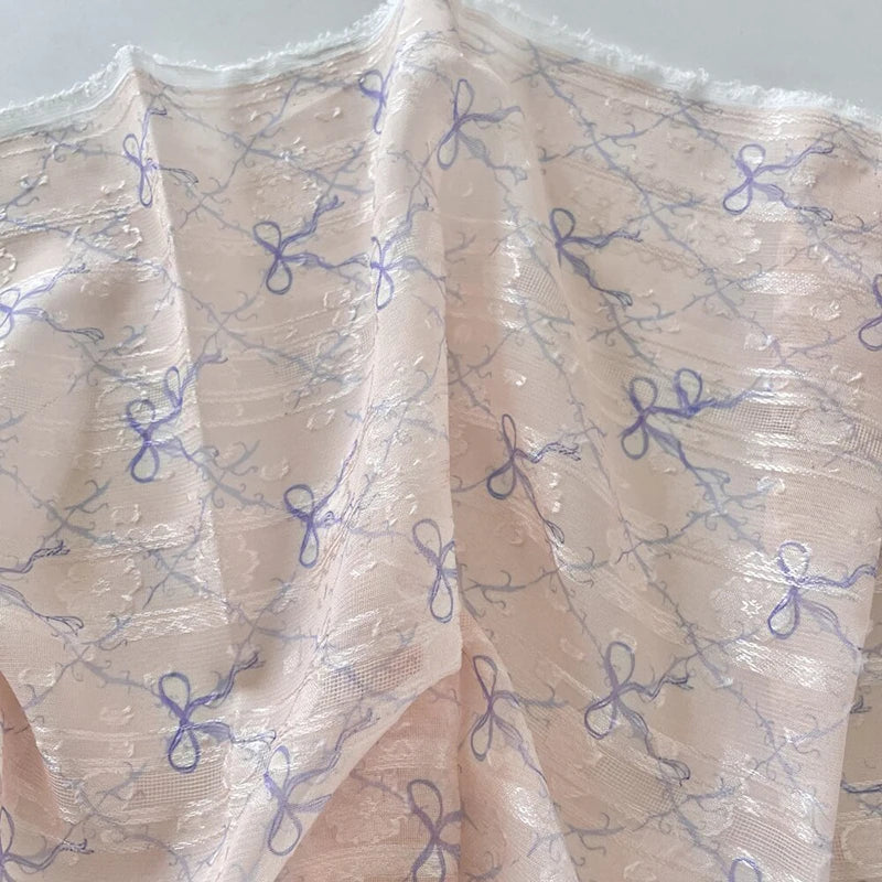 tissu polyester coton rose clair beige bleu clair motif nœuds fleurs élégant romantique 150cm