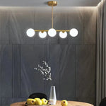 Suspension lumineuse moderne or blanc sphères blanches structure dorée salon chambre