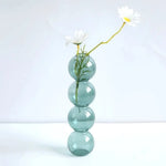 vase moderne transparent sphères empilées jaune clair rose bleu vert brun