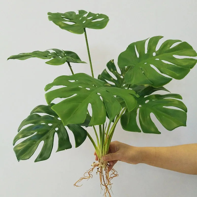 plantes artificielles vertes feuilles larges moderne decoration intérieure feuilles nervures perforations racines apparentes minimaliste