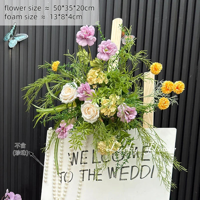 décoration murale naturelle composition florale variée couleurs vives rustique bienvenue mariage