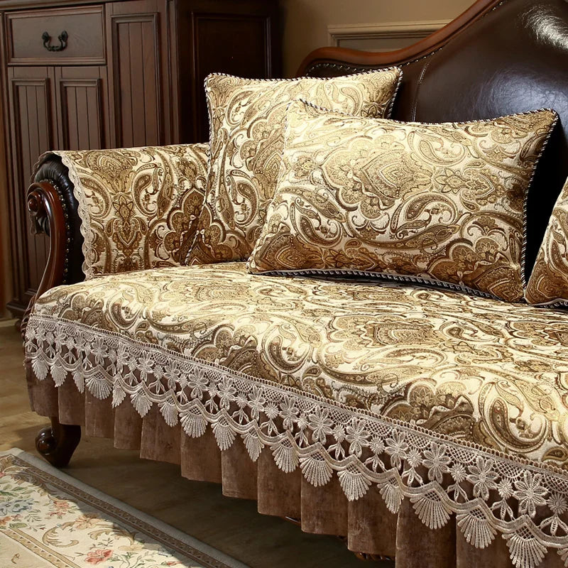 Élégant canapé en bois foncé avec des oreillers et une housse motif baroque or et beige, orné d'une dentelle blanche raffinée sur le pourtour.