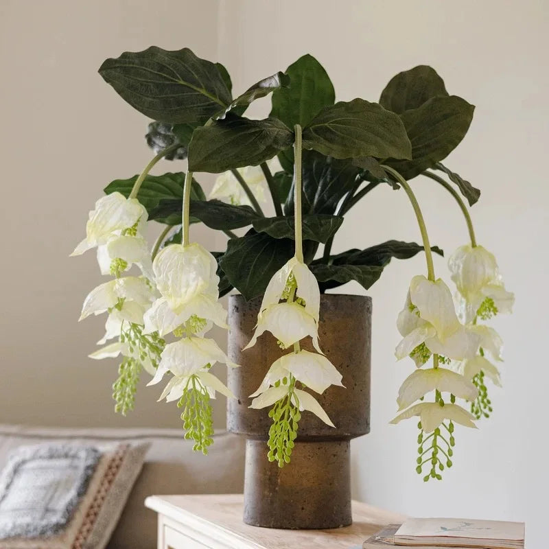 branche artificielle fleurs naturelles extérieur accrochées blanc vert feuilles larges minimaliste