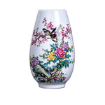 Vase en porcelaine avec motifs floraux colorés de fleurs et d'oiseaux.