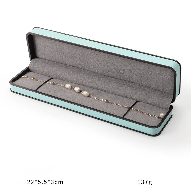 boîtes bijoux cuir beige turquoise intérieur noir moderne emballage présentation anneaux haute qualité
