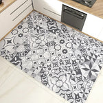 Tapis décoratif en vinyle avec motif géométrique noir et blanc dans une cuisine moderne.