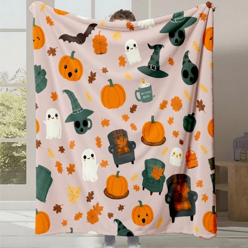 Une couverture douillette avec des motifs d'automne mignons et festifs, comme des citrouilles, des feuilles d'érable et des fantômes.