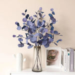 bouquet artificiel feuilles ovales moderne vase transparent support doré couleurs vives exposition intérieure