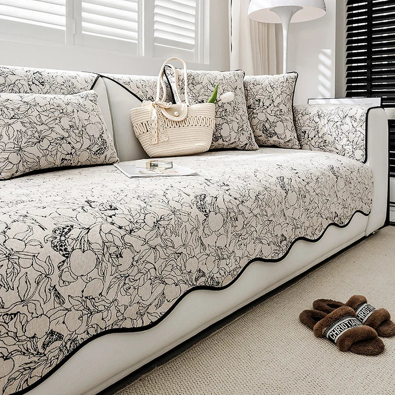 Cette image montre un canapé confortable avec des coussins et un sac en osier posé sur un tapis moelleux, dans un environnement lumineux et apaisant, créant une atmosphère chaleureuse et accueillante.