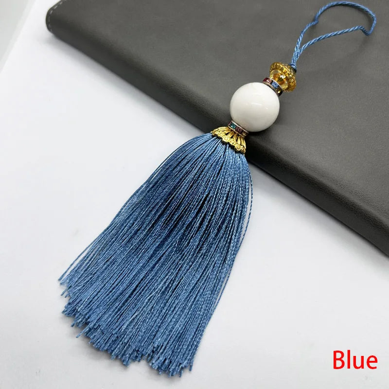 pompon décoratif gris bleu doré vert violet tissu finement tressé élégant moderne blanche chaîne