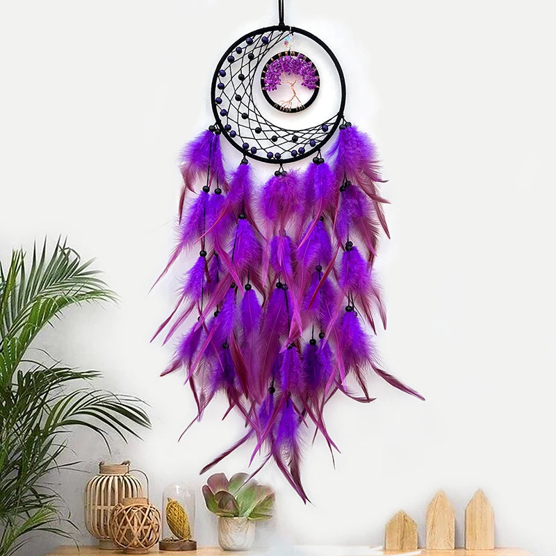 L'image montre un attrapeur de rêves décoratif avec des plumes violettes et roses qui pendent de l'anneau noir en forme de lune, créant une belle et mystique pièce de décoration.