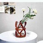 vase moderne transparent tiges entrelacées orange sans fleur