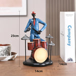 statues miniatures musiciens guitare saxophone trombone batterie décoration intérieure moderne stylisée