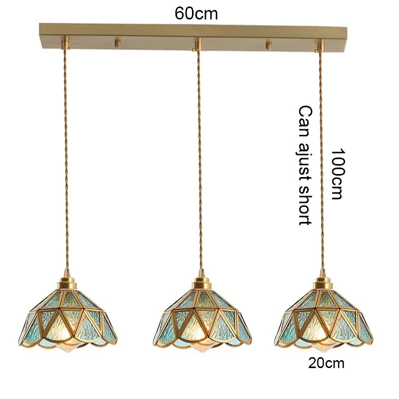 suspension lumineuse verre teinté art deco or marron bleu clair motifs géométriques opacité chaînes