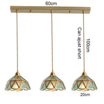 suspension lumineuse verre teinté art deco or marron bleu clair motifs géométriques opacité chaînes