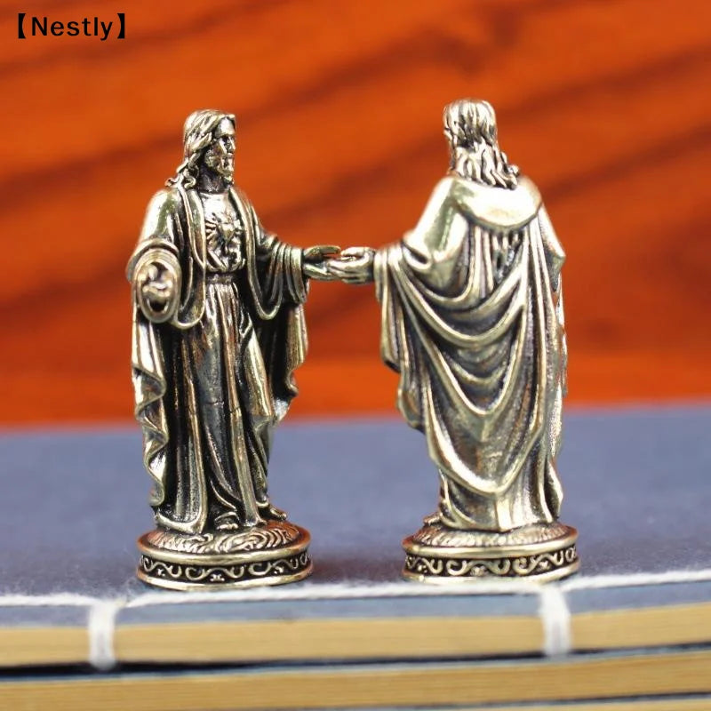 statuette religieuse argentée détail sculpté classique figure humaine vêtements larges base décorative