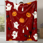 Couverture rouge avec des motifs d'Halloween, incluant des fantômes, des citrouilles et des araignées.