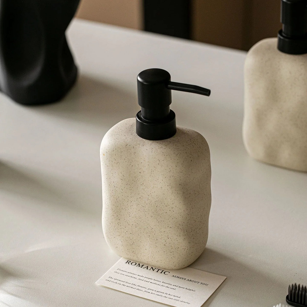 distributeur savon liquide céramique beige texture granulée minimaliste accessoire salle bains après shampooing lotion