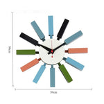 Horloge murale mid century bleu orange noir aiguilles rouge cadran blanc atomique époque