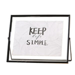 cadre photo moderne minimaliste or noir pieds triangulaires texte simple verre