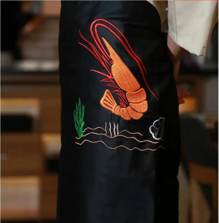 tablier cuisine noir broderie poisson orange service alimentaire femme drap fin opaque traditionnel