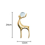 statues cerfs dorées boule cristal moderne décoration vase fleurs artificielles tableau noir