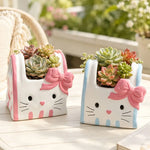 cache pot résine forme chat blanc bleu rose yeux noirs narines roses sourcils noirs