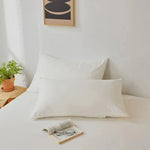 taies d'oreiller lisses polyester coton gris bleu rose blanc modernes literie décoration chambre voyage