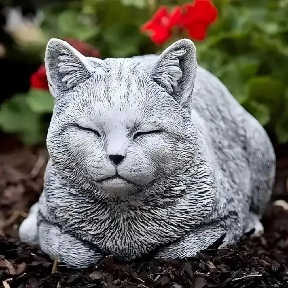 ornement zen statue chat gris allongé texture pierreuse jardin fleurs plantes