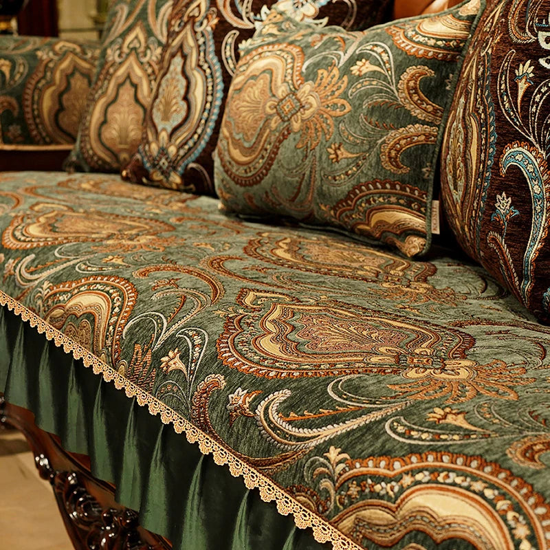 Riche tissu décoratif aux motifs floraux et arabesques traditionnels dans des tons verts, bruns et dorés, créant une ambiance chaleureuse et élégante.