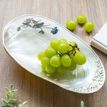assiette ovale motifs floraux ornementations multicolores classique élégant fruits décoratif blanc table manger