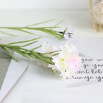 décoration intérieure bouquet fleurs artificielles bleues blanches roses longues tiges vertes vase transparent festonnée