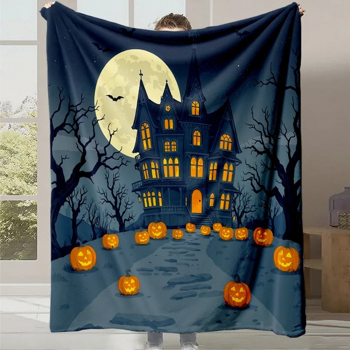 Couverture décorative représentant une maison hantée par la nuit d'Halloween, avec une grande lune, des arbres sans feuilles, des chauves-souris et de nombreuses citrouilles éclairées sur un chemin menant à la maison.