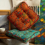 coussin carré bleu orange motif floral pompons boho chic décoration salon sol canapé