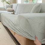 housse canapé extensible beige clair motif feuilles imprimées moderne protection meubles