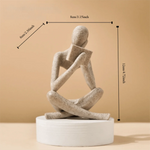 figurine deco moderne or noir blanc personne assise livre socle chambre abstraction minimalisme